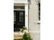 Close-up of a home's front door with sidelight window and potted greenery at 62 Society St, Charleston, SC 29401