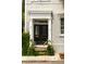 Charming exterior view of a home with a black front door and lush greenery at 62 Society St, Charleston, SC 29401
