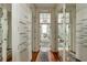 Hallway with hardwood floors, built-in storage, and bathroom view at 62 Society St, Charleston, SC 29401