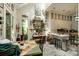 Open kitchen features white cabinets, marble floors, and an eat-in island with modern black counter stools at 62 Society St, Charleston, SC 29401