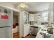 Efficient kitchenette featuring white cabinetry and modern stainless steel appliances at 62 Society St, Charleston, SC 29401