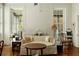 Comfortable living room with bright windows, a ceiling fan, and hardwood floors, perfect for relaxing at 62 Society St, Charleston, SC 29401