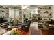 Cozy living room with lots of shelving and a view to the dining room at 62 Society St, Charleston, SC 29401