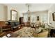 Elegant living room with chandelier, fireplace, antique furniture and hardwood floors at 62 Society St, Charleston, SC 29401
