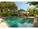 Large swimming pool surrounded by lush greenery and a patio area at 62 Society St, Charleston, SC 29401