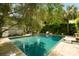 A stunning in-ground pool is surrounded by trees creating a private outdoor space at 62 Society St, Charleston, SC 29401