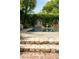 Private pool area with stone steps and vine-covered walls and arched gate at 62 Society St, Charleston, SC 29401