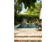 This in-ground pool is surrounded by beautiful landscaping and features a peaceful outdoor retreat with dining area at 62 Society St, Charleston, SC 29401