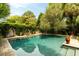This in-ground pool offers a beautiful outdoor oasis featuring stone work, a fountain, and beautiful landscaping at 62 Society St, Charleston, SC 29401
