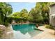 This in-ground pool features beautiful stonework, a fountain, lush landscaping, and privacy from the neighbors at 62 Society St, Charleston, SC 29401