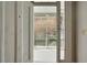 View of the porch with a white ceiling and walls as seen from inside the door at 62 Society St, Charleston, SC 29401