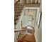 Bright staircase with chandelier and access to the porch and filled with plenty of natural light at 62 Society St, Charleston, SC 29401