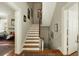 Staircase with white risers and wood treads leads to the upper level, enhancing the home's appeal at 62 Society St, Charleston, SC 29401