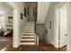 Staircase with white risers and wood treads leads to the upper level, enhancing the home's appeal at 62 Society St, Charleston, SC 29401