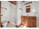 Traditional bathroom with a shower, toilet, vanity, and wood accents at 625 Ocean Blvd, Isle of Palms, SC 29451