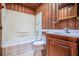 Bathroom features shower-tub combo, toilet, vanity, and white wainscoting at 625 Ocean Blvd, Isle of Palms, SC 29451