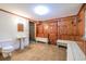 Rustic bathroom with wood paneled walls, simple fixtures, and vintage-style charm at 625 Ocean Blvd, Isle of Palms, SC 29451