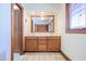 Bathroom featuring a wooden vanity with double sinks and a large mirror with a wood trim at 625 Ocean Blvd, Isle of Palms, SC 29451