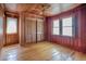 Cozy bedroom features wood paneling, hardwood floors, closet, ceiling fan and natural light at 625 Ocean Blvd, Isle of Palms, SC 29451