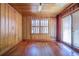 Bedroom featuring hardwood floors, wood paneling, and abundant natural light at 625 Ocean Blvd, Isle of Palms, SC 29451