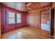 Bright bedroom featuring hardwood floors, wood paneling, ceiling fan, and natural light at 625 Ocean Blvd, Isle of Palms, SC 29451