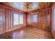Bedroom features wood paneling, hardwood floors, natural light, and a ceiling fan at 625 Ocean Blvd, Isle of Palms, SC 29451