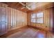 This bedroom features warm wood paneling, a ceiling fan, and a window with natural light at 625 Ocean Blvd, Isle of Palms, SC 29451