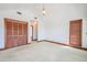 Large bedroom with carpeted floors, featuring a vaulted ceiling, closet, and a window at 625 Ocean Blvd, Isle of Palms, SC 29451