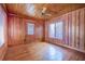 Bedroom with wood paneling, hardwood flooring, natural light, and a ceiling fan at 625 Ocean Blvd, Isle of Palms, SC 29451