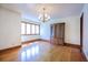 Bright dining room with hardwood floors, large window, and vintage china cabinet at 625 Ocean Blvd, Isle of Palms, SC 29451