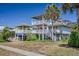 Charming two-story beach home featuring multiple decks, covered parking, and well-maintained landscaping at 625 Ocean Blvd, Isle of Palms, SC 29451