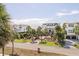 Beautiful exterior view of beach houses with palm trees and driveways on a sunny day at 625 Ocean Blvd, Isle of Palms, SC 29451