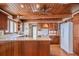 Cozy kitchen with wood-beamed ceiling, hardwood floors, and white appliances at 625 Ocean Blvd, Isle of Palms, SC 29451