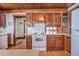 Compact kitchen with wood-beamed ceiling, hardwood floors, and modern appliances at 625 Ocean Blvd, Isle of Palms, SC 29451