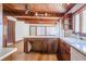 Well-lit kitchen with wood-beamed ceiling, hardwood floors, and a large island at 625 Ocean Blvd, Isle of Palms, SC 29451