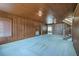 Large living room featuring carpet floors, wood paneling, and staircase to the next level at 625 Ocean Blvd, Isle of Palms, SC 29451