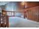 Expansive living room boasts wood paneling, and a staircase leading to the upper level at 625 Ocean Blvd, Isle of Palms, SC 29451