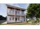 Two-story home featuring a double porch and a beautifully landscaped yard at 63 Montagu St, Charleston, SC 29401