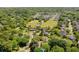 Community aerial view featuring a large green space with tennis court, surrounded by homes and mature trees at 699 Castle Pinckney Dr, James Island, SC 29412