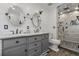 Clean bathroom with gray double vanity, two mirrors, wood-look tile floors and shower with glass doors at 699 Castle Pinckney Dr, James Island, SC 29412
