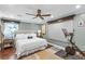 Comfortable bedroom with a ceiling fan, hardwood floors, a king-sized bed and an exercise bike at 699 Castle Pinckney Dr, James Island, SC 29412