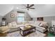 Cozy living room with a large sectional couch, hardwood floors covered with a rug, ceiling fan and a flat-screen TV at 699 Castle Pinckney Dr, James Island, SC 29412