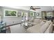 A living room featuring a fireplace, natural light, and access to the pool at 699 Castle Pinckney Dr, James Island, SC 29412
