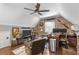 Bright, well-lit office with wood-look accent wall, desk, and chair; hardwood floors and a ceiling fan at 699 Castle Pinckney Dr, James Island, SC 29412