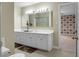 Bathroom featuring a double vanity sink, floral mats, and a large mirror with lights at 702 Minus St, Saint George, SC 29477