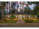 Charming brick home with a welcoming front porch and a well-manicured lawn surrounded by mature trees at 702 Minus St, Saint George, SC 29477