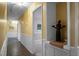 Hallway with yellow walls and white trim featuring a statue display and access to other rooms at 702 Minus St, Saint George, SC 29477