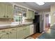 Efficient kitchen featuring updated stainless steel appliances, wood countertop, and hardwood floors at 702 Minus St, Saint George, SC 29477