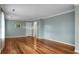 Spacious living room featuring refinished hardwood floors, fresh paint, crown molding, and ample natural light at 702 Minus St, Saint George, SC 29477