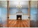 Elegant living room showcasing hardwood floors, fireplace, and crystal chandelier at 702 Minus St, Saint George, SC 29477